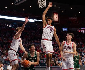 Three University of Arizona men's basketball players take on a player from Eastern New Mexico in McKale Center on Oct. 21. Arizona lead 64-26 at halftime. 