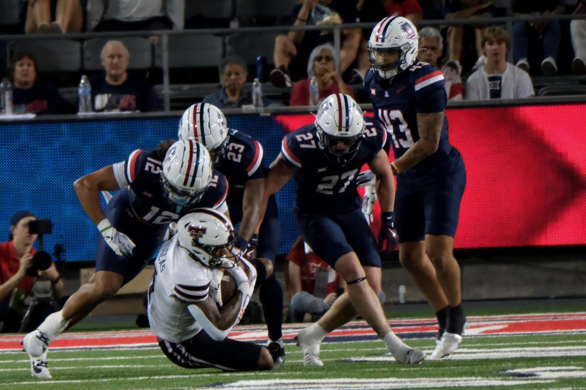 the Arizona Wildcats defense closes in on Caleb Douglas of Texas Tech during their game on Oct. 5 at Arizona Stadium. Texas Tech dominated the first half.