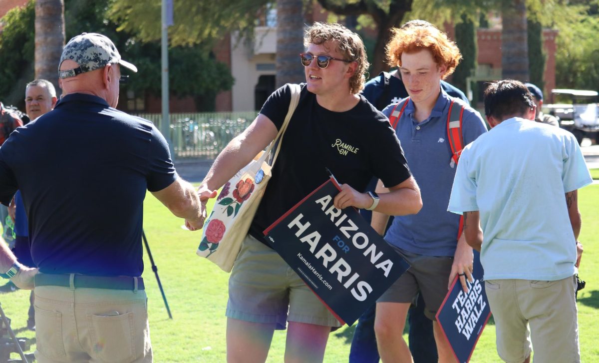 A student shakes hands with Senator Mark Kelly on the UA Mall Oct. 15. Kelly held a meet-and-greet to rally for the Harris-Walz campaign.