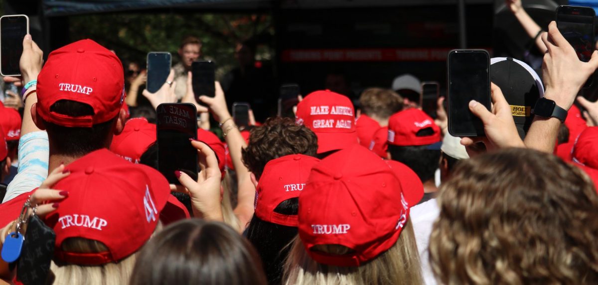 Dozens of students record TikTok influencer Bryce Hall as he pretends to ask Charlie Kirk a crowd question near the student union on Oct. 16. Hall joked that he changed his pronouns to they/them and asked if he was allowed to vote twice because of it.