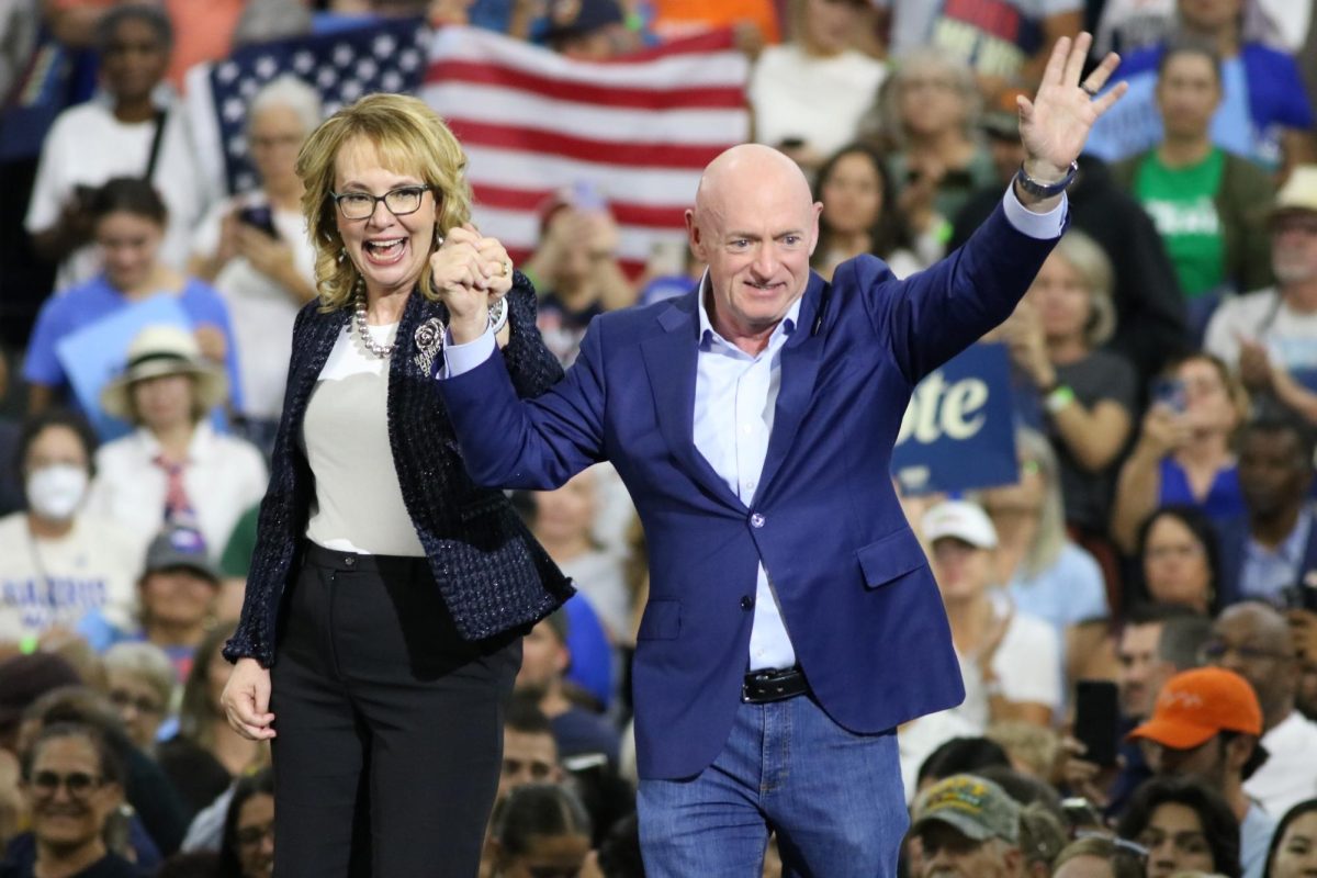 Former Rep. Gabby Giffords and U.S. Senator Mark Kelly walk onto the stage inside the Cole and Jeannie Davis Sport Center for Oct. 18. The couple spoke about the shooting that left Giffords critically injured.