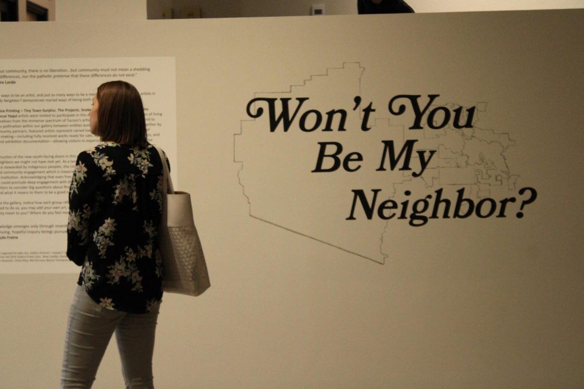 A woman reads the “Won’t You Be My Neighbor” exhibit description on the wall on Sept. 19. The “Won't You Be My Neighbor?” exhibit is in collaboration with ArtWorks and artists from Tohono O’odham and Pascua Yaqui Nations.