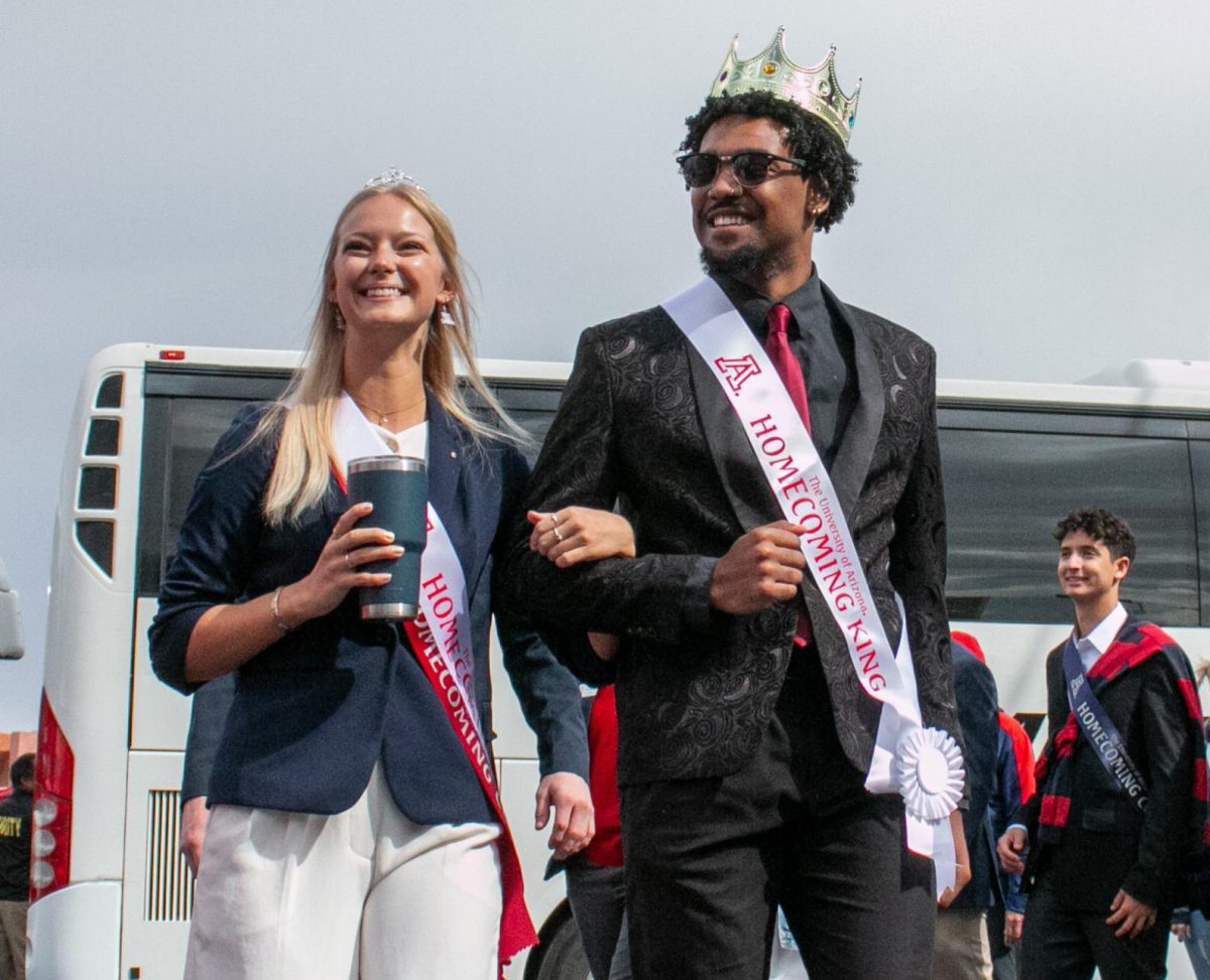 Homecoming Queen Ella Frank and Homecoming King Diego Gonzales Jr. walk to Arizona Stadium on Saturday, Oct. 19, at the University of Arizona tailgate. Frank was nominated by the Chi Omega sorority, while Gonzales was nominated by Arizona Mortarboard.