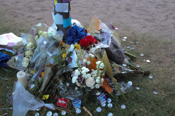 People placed flowers, candy, candles and letters at Minhaj Jamshidi memorial at the volleyball courts next to Arizona Sonora Hall. Jamshidi, a 19-year-old Pima County Community College student, was shot and killed when a fight broke out during Sunday’s game. 