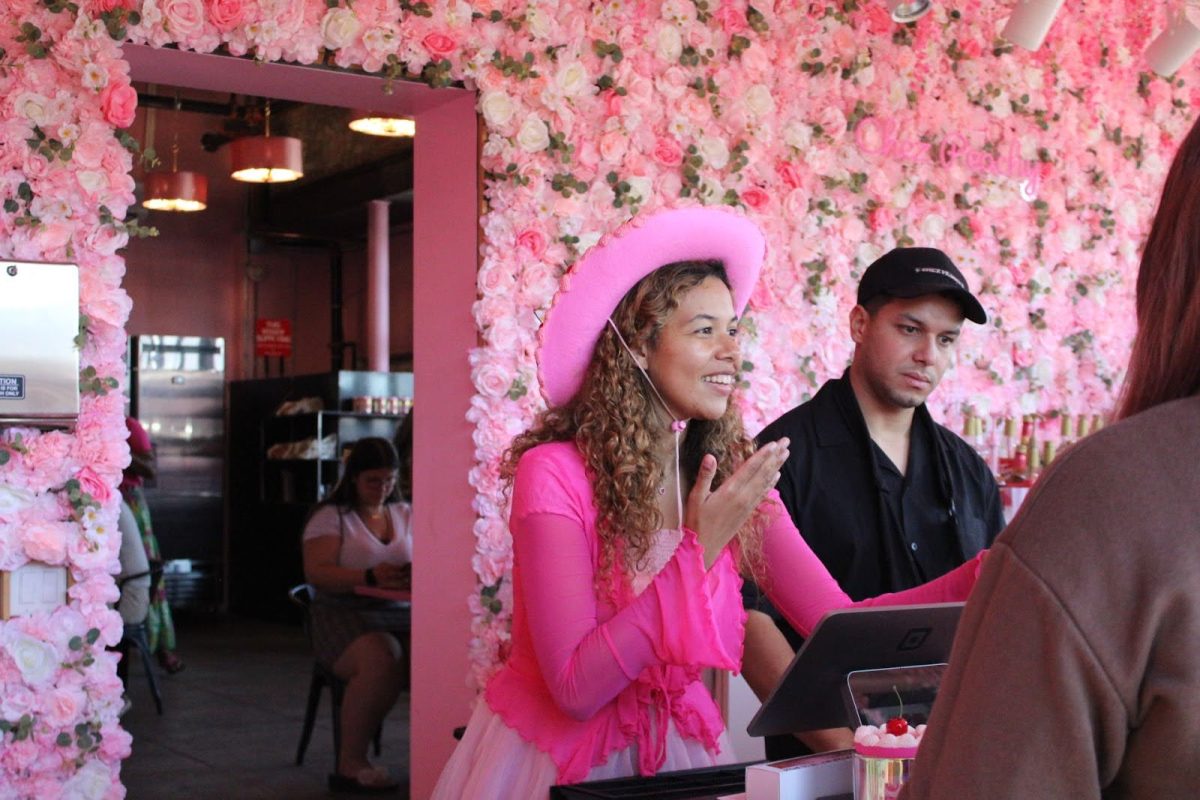 Christa Lebron, also known as Chez Peachy, takes orders during the grand opening of her new bento cake cafe on Sixth Avenue on Oct. 5. She runs the business with her husband.