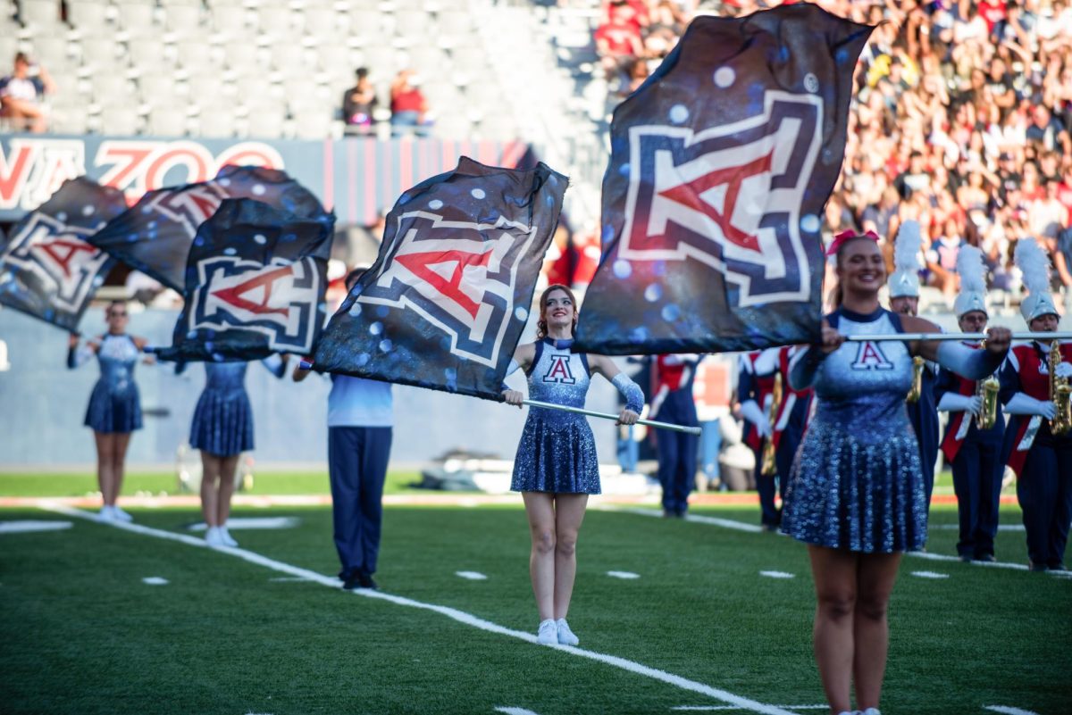 The University of Arizona color guard holds their flags on Oct. 26 at Arizona Stadium. They put on a performance with the band prior to the flag being presented.