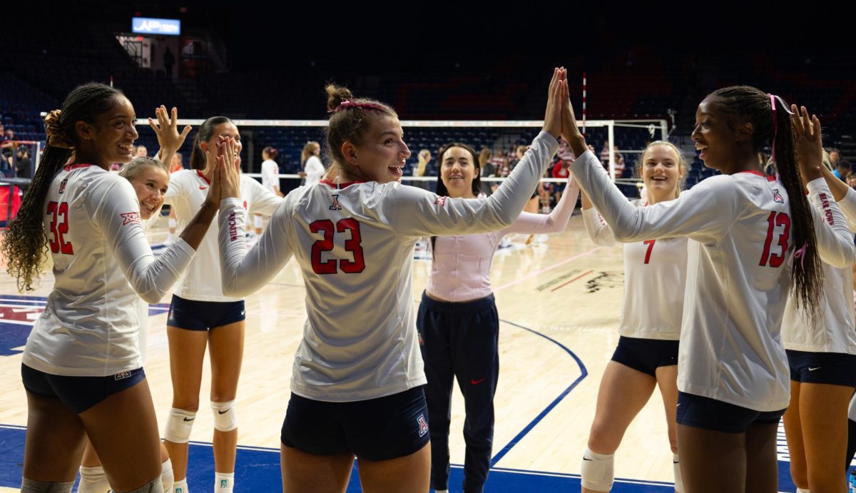 The University of Arizona volleyball team joins hands on Oct. 16 against the University of Colorado Boulder. Arizona fell to Boulder in five sets.