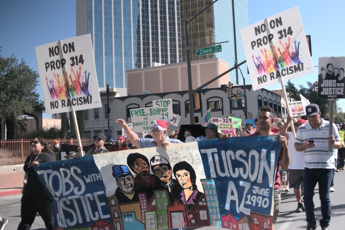 Community members protesting Proposition 314 march on Congress Street in Downtown Tucson, heading toward Tucson City Hall. Proposition 314, also known as the "Secure the Border Act" would implement various strict border policies. 