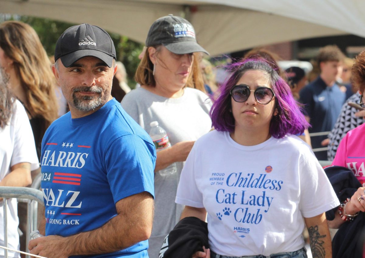 Two people wait in line at the Obama rally on Oct. 18 at the Cole and Jeannie Davis sports center. Obama came to Tucson for the get-out-the-vote rally. 