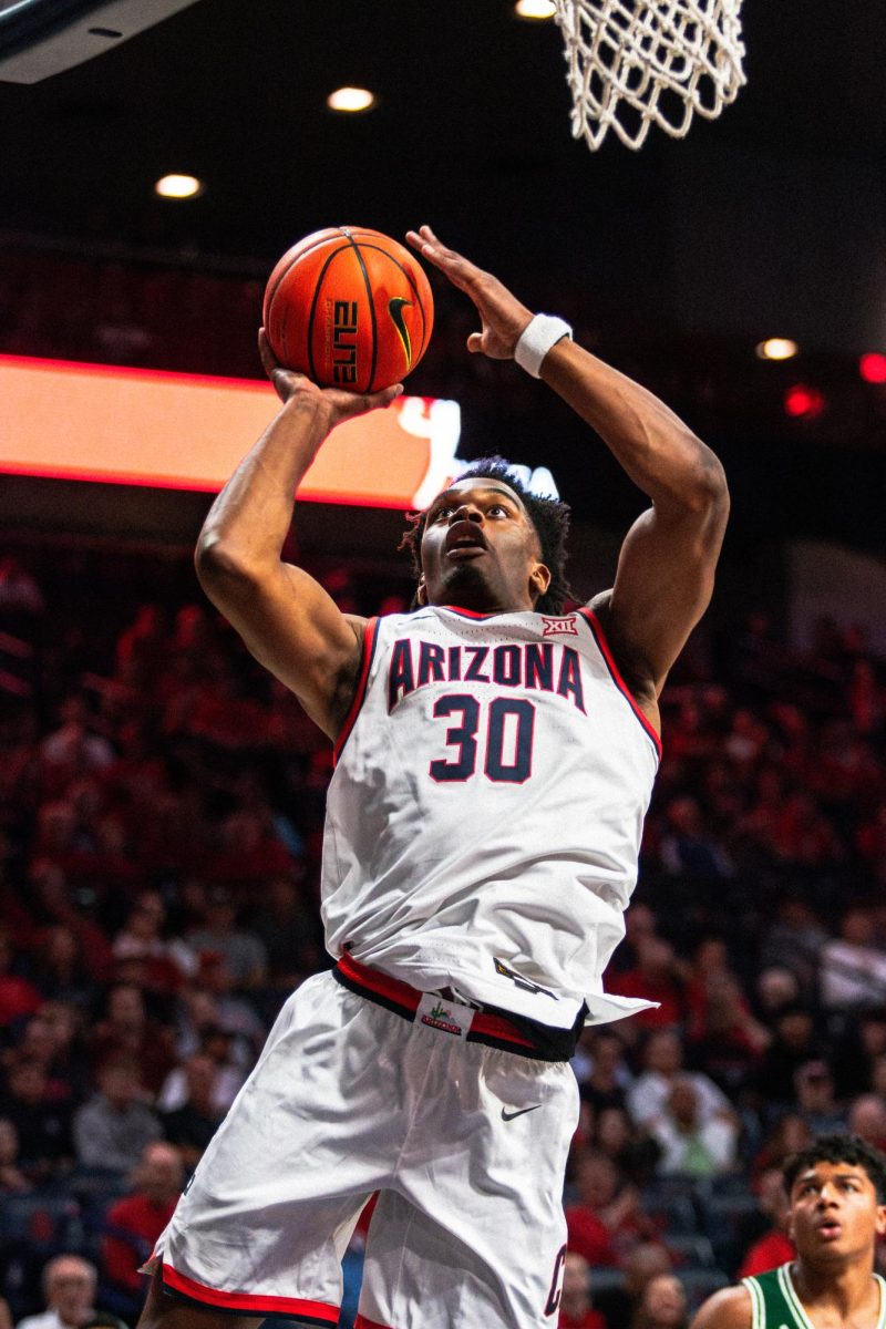 University of Arizona basketball player Tobe Awaka goes for a dunk attempt in McKale Center during an exhibition match with Eastern New Mexico on Oct. 21. The Greyhounds had 20 turnovers, and the Wildcat's converted that into 33 points.  