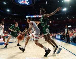 University of Arizona basketball player Carter Bryant tries to find an open spot to pass the ball in McKale Center on Oct. 21 against Eastern New Mexico. The Wildcats went 27 of 35 from the free throw line. 