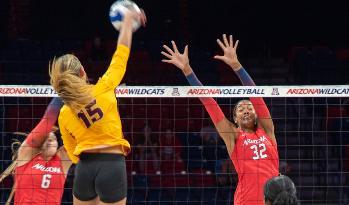 University of Arizona volleyball players Avery Scoggins (#6) and Alayna Johnson (#32) block the ball together on Oct. 24 against Arizona State University in McKale Center. The Wildcats out-blocked the Sun Devils 2.0-0.0 but Arizona only hit .146 in the set.