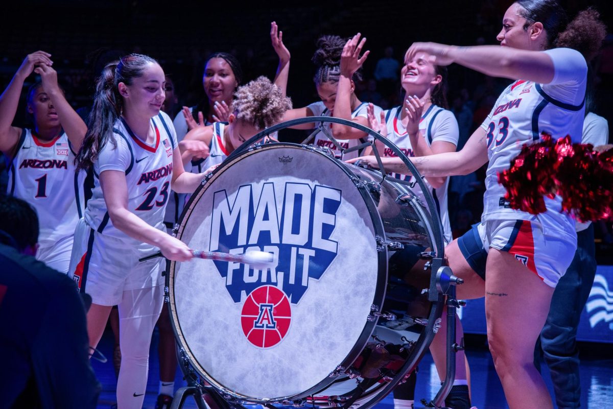 University of Arizona women's basketball player, Paulina Paris, hits the drum on Oct. 25 in McKale Center. After every Wildcat win, the UA player who had the best game bangs a titanic drum the number of wins Arizona has.