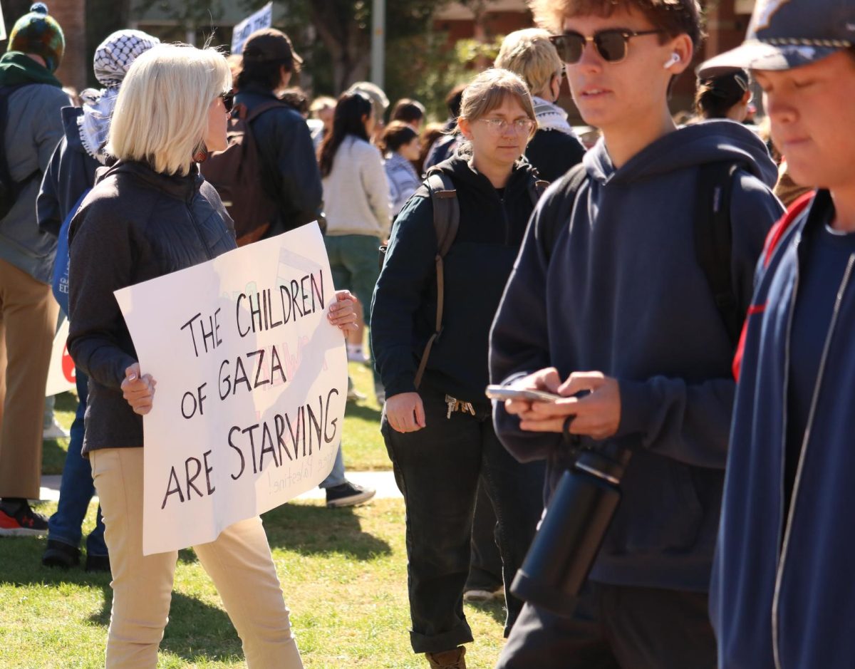 A protester holds a sign reading "The children of Gaza are starving" on the UA Mall on Nov. 7. Jewish Voice for Peace - Tucson, SJP at UA and the Party for Socialism & Liberation were some of the organizations supporting the protest.