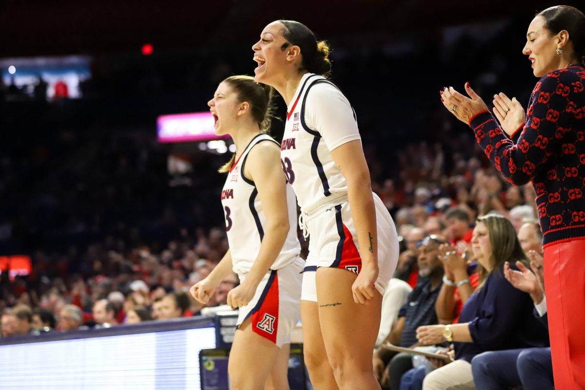 Isis Beh celebrates on the sideline in McKale Center on Nov. 12. Arizona is now 4-0 on the season.