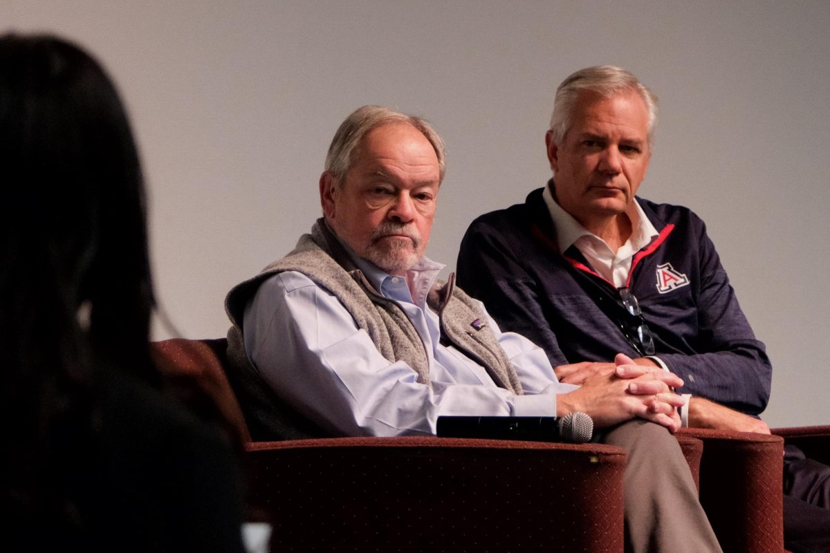 Ronald Marx (left) and John Arnold (right) listen to a student as she asks a question during an ASUA town hall in Gallagher theater on Nov. 20. The proposed move would have displaced many student resources.