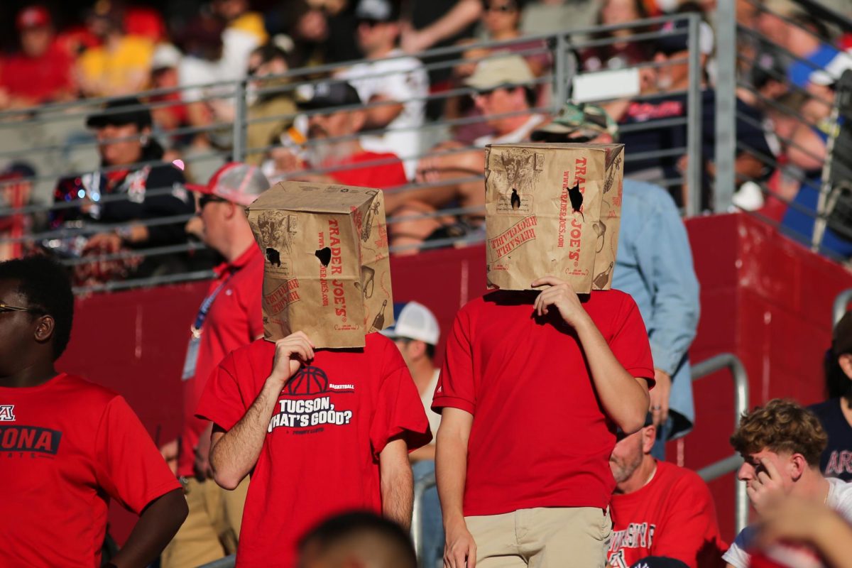 Arizona fans wear bags over their head while trailing Arizona State 42-7 during the 2024 Territorial Cup on Nov. 30 at Arizona Stadium.  The team ended the season 4-8.