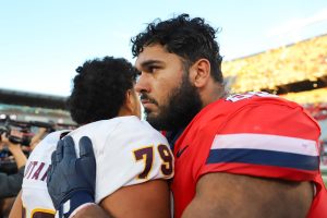 Alexander Doost shares an embrace with an Arizona State University player after a 49-7 loss at Arizona Stadium on Nov. 30.  ASU reclaims the Territorial Cup after Arizona won the previous three meetings