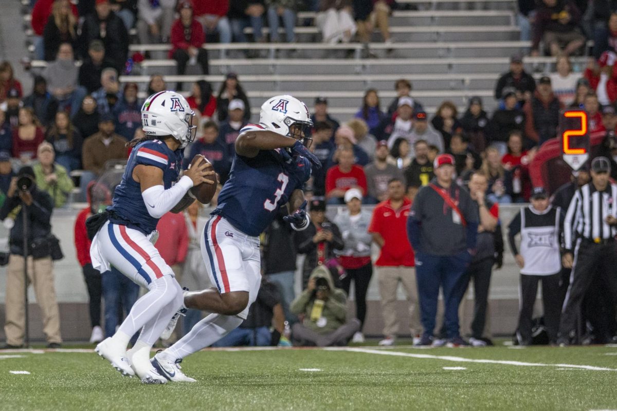 Arizona Football players Kedrick Reescano (3) and Noah Fifita (11) after the snap against Houston on Nov. 15 at Arizona Stadium. 