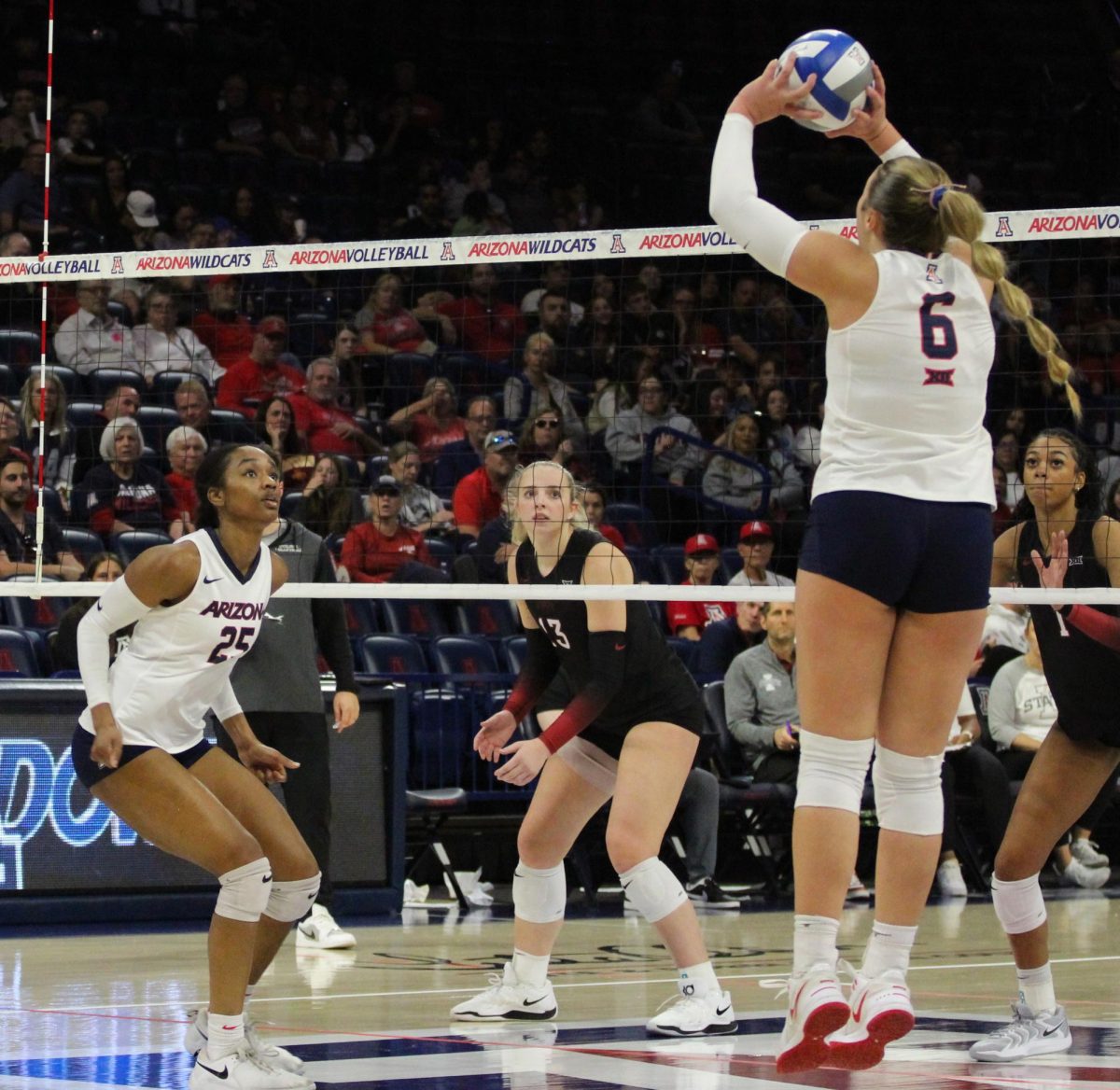 University of Arizona volleyball player Avery Scoggins passed the ball to Kiari Robey in McKale Center on Nov. 23. Scoggins is a freshman and a setter.