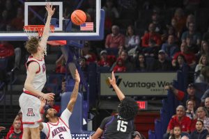 University of Arizona forward, Henri Veesaar (13), leaps to block a shot from Texas Christian University player David Punch (15) in McKale on Dec. 30. Veesaar scored 18 points, making this his highest-scoring game this season.