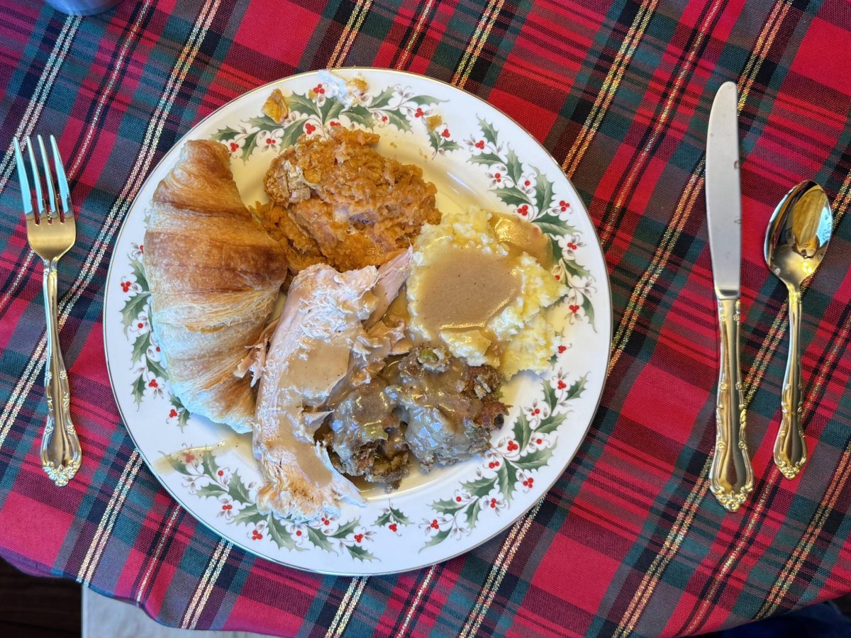 Sugar-glazed ham, a side of collard greens and macaroni and cheese on a plate for Thanksgiving dinner on Nov. 28. My dad also made a whole turkey with some stuffing, but my sister and I always prefer ham.