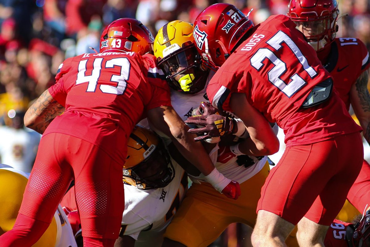 Dalton Johnson and Owen Goss stand up the ASU ball carrier in the first quarter of the 2024 Territorial Cup on Nov. 30 at Arizona Stadium. Both players combined for 12 tackles.