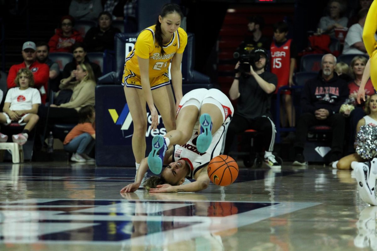 University of Arizona womens basketball player Jada Williams falls and rolls backwards while handling the ball on Dec. 10 in McKale Center against California State University, Bakersfield. Williams recovered from the fall.