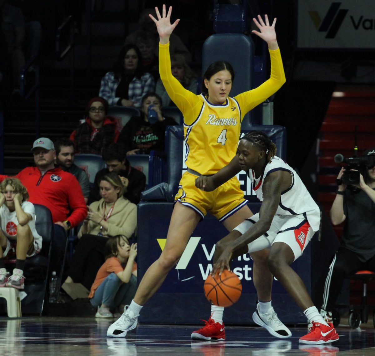 University of Arizona womens basketball player Sahnya Jah wards of a California State University, Bakersfield defender on Dec. 10 in McKale Center.  The Wildcats scored 27 points from the Roadrunners' 23 turnovers.