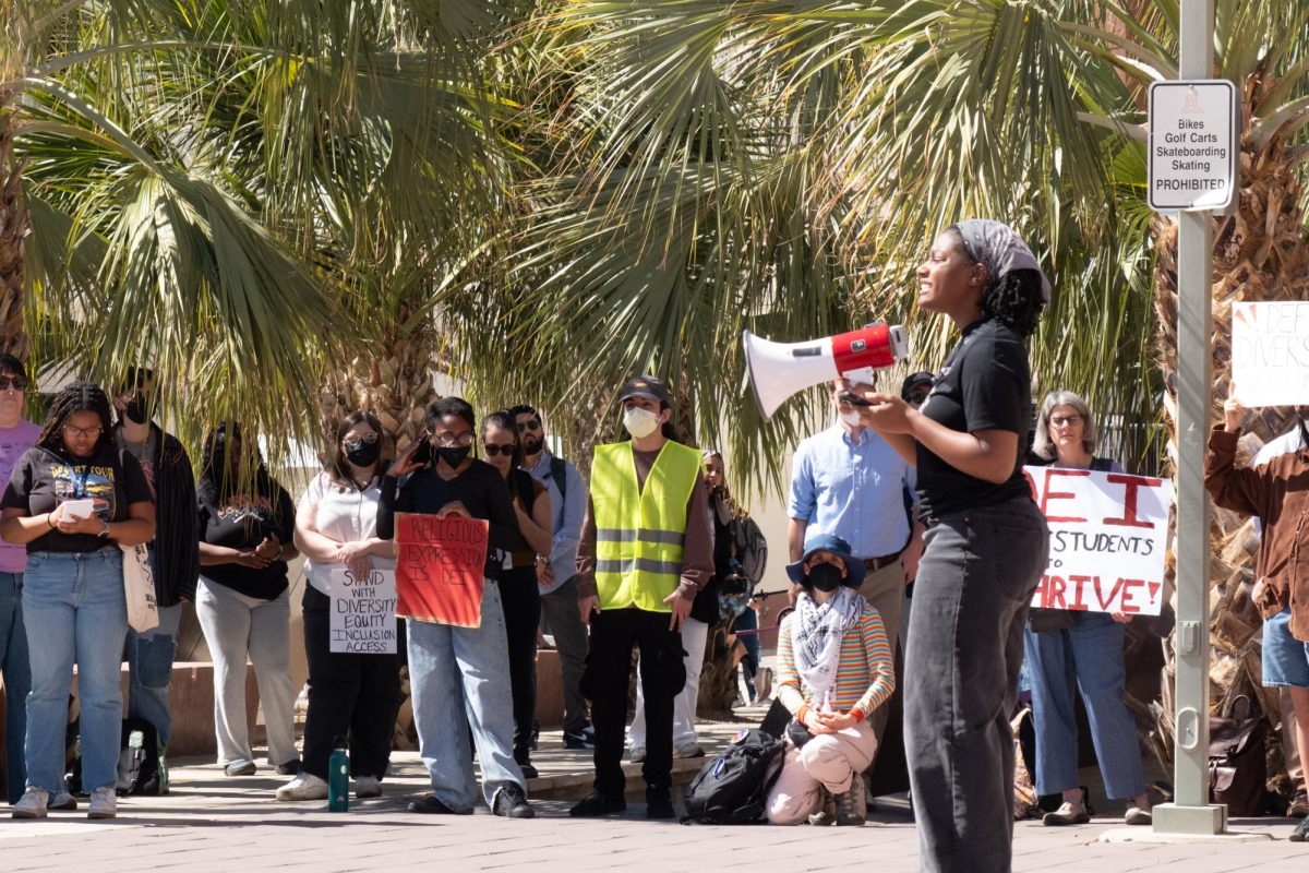 A protest leader uses a megaphone to speak to protesters at the Administration building on Feb. 27. The protest garnered the attention of dozens of students and faculty members.