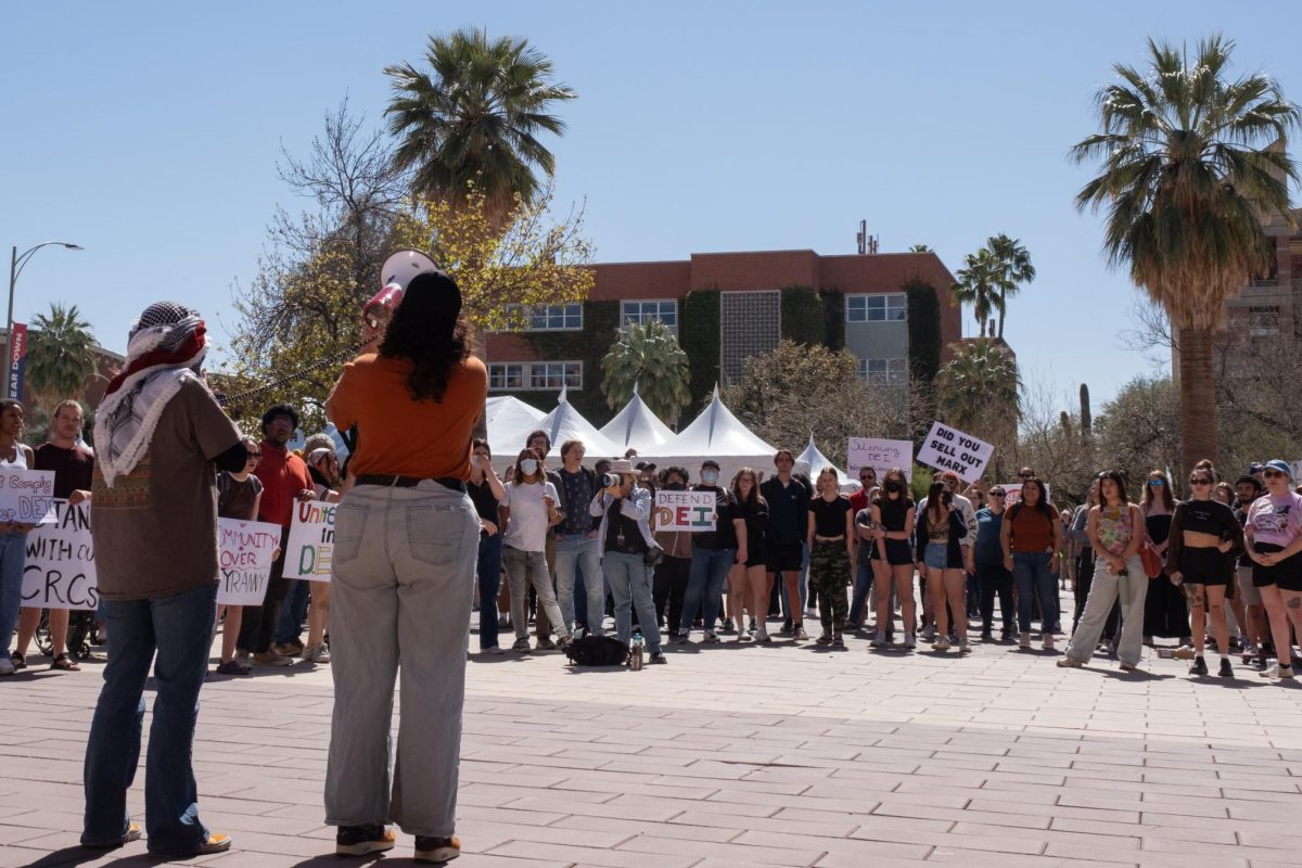 Protest leaders use megaphones to chant to protesters in front of the Administration building on Feb. 28. Protesters brought signs to show their support.