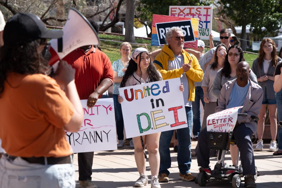 United in D.E.I reads one sign during a protest at the Administration building on Feb. 27. Protesters used megaphones to demand that the University keeps its DEI policies in place.