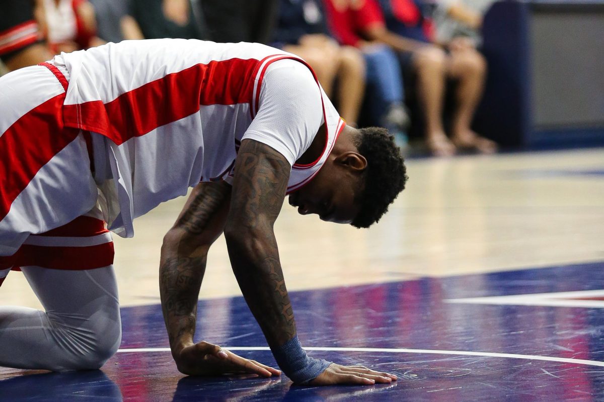 KJ Lewis takes a moment under the basket after a foul against Houston on Feb. 15 in McKale Center.  Lewis led the team with seven rebounds.