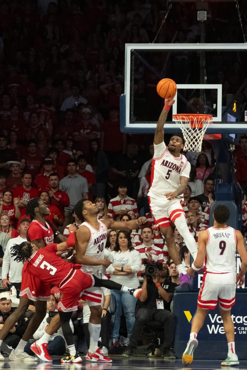 KJ Lewis blocks a shot by Elijah Hawkins during the Wildcats’ game against the Texas Tech Red Raiders on Feb. 8 in McKale Center. The Red Rangers kept the Wildcats on their toes with 12 points from the 3-point line.