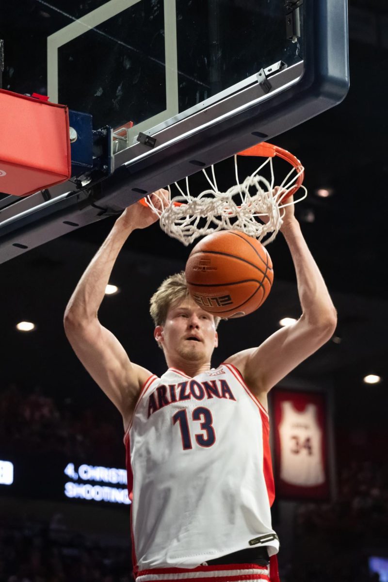 Forward Henri Veesaar makes a dunk against the Red Raiders during their game on Feb. 8 in McKale Center. Veesaar proved to be an offensive powerhouse with 15 points in his 29 minutes on the court.