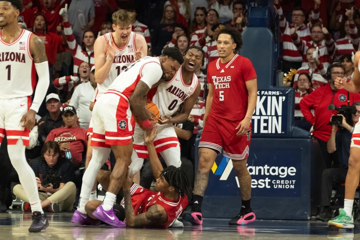 Arizona players KJ Lewis (#5) and Jaden Bradley (#0) wrestle the ball free from Texas Tech player JT Toppin during their game on Feb. 8 in McKale Center. The Wildcats played a physical game against their new Big 12 opponents.