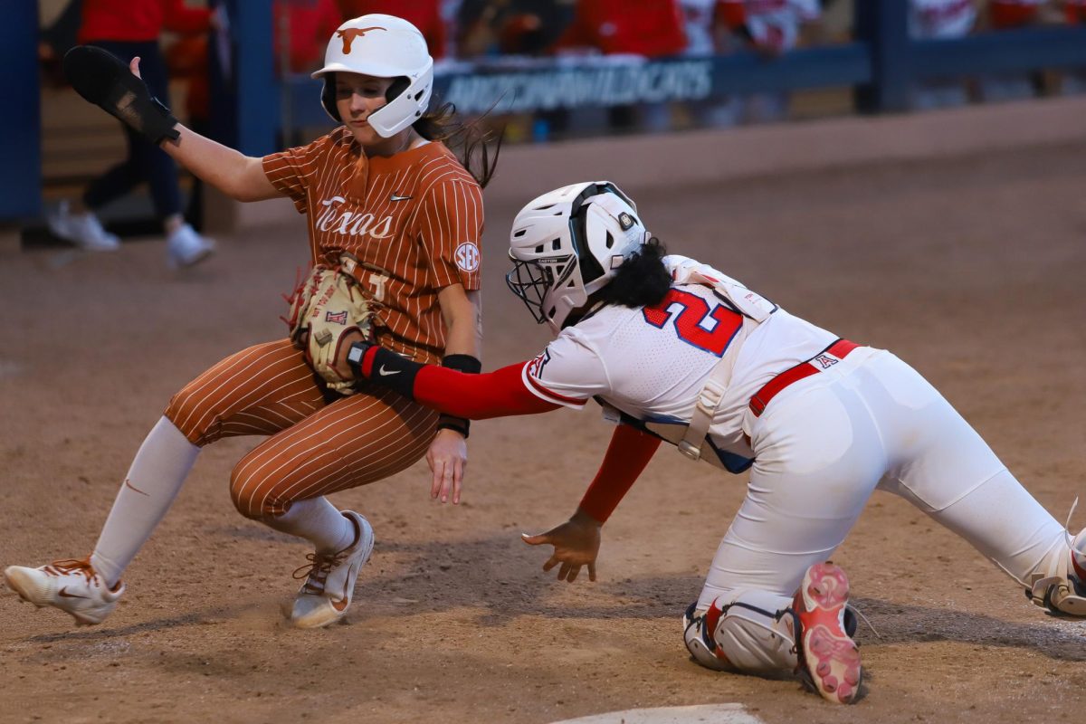 Arizona catcher Syndey Stewart tags a Texas baserunner out at home to save a run at Hillenbrand Stadium on Feb. 22.  This game marked the first time softball played the #1 team at home since 1998.