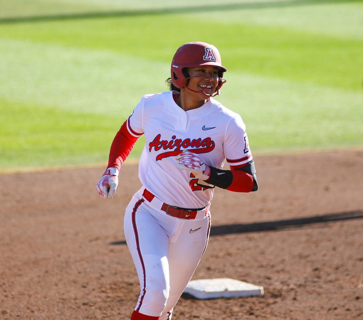 Sydney Stewart flashes a smile as she rounds the bases after hitting a 3 run homerun in the first inning to tie the game with Texas at Rita Hillenbrand Stadium.  Arizona didn't score again until the bottom of the seventh inning.