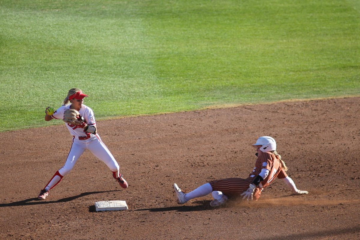 Infielder Logan Cole turns a double play to stop Texas' scoring threat on Feb. 22 at Rita Hillenbrand Stadium.  Arizona manages to strand nine Texas runners on base.