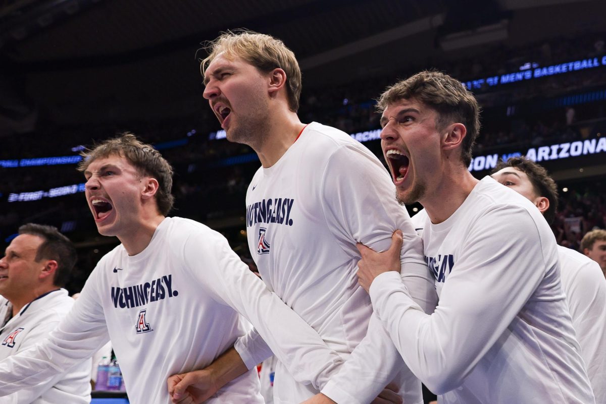 The Arizona bench celebrates late free throws to fend off the University of Oregon in the Round of 32 on March 23 in Seattle, Washington in Climate Pledge Arena.