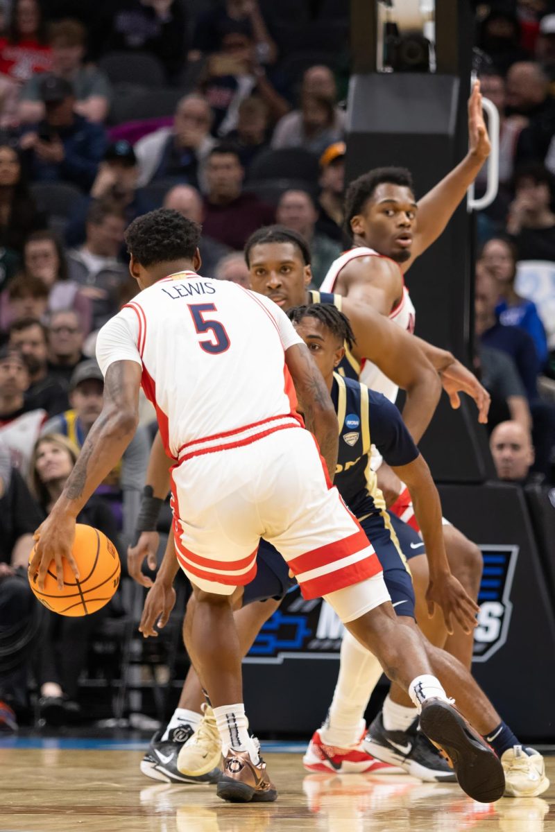 KJ Lewis dribbles into the Akron Zips defense during the first round of the NCAA tournament on March 21 in Climate Pledge Arena in Seattle, Wash. 