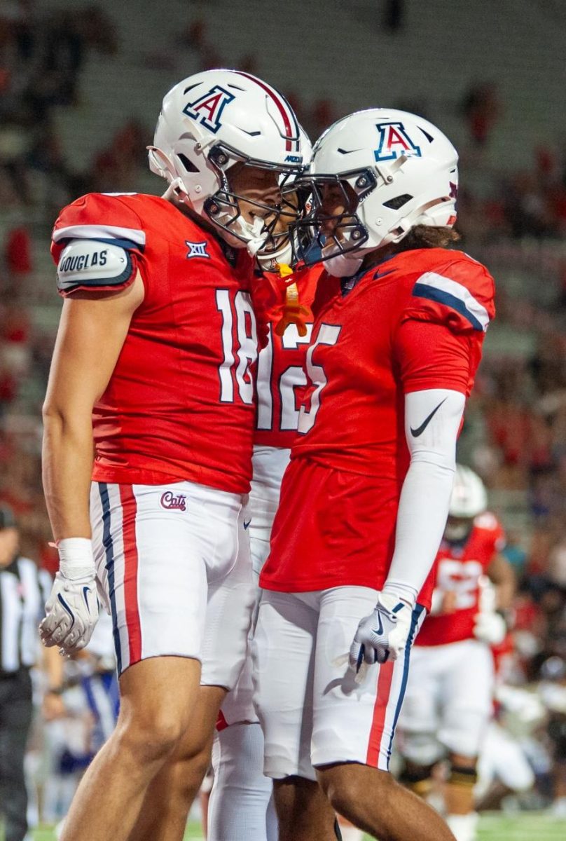 Brandon Phelps celebrates his touchdown with teammates against Weber State on Sep. 6 at Arizona Stadium