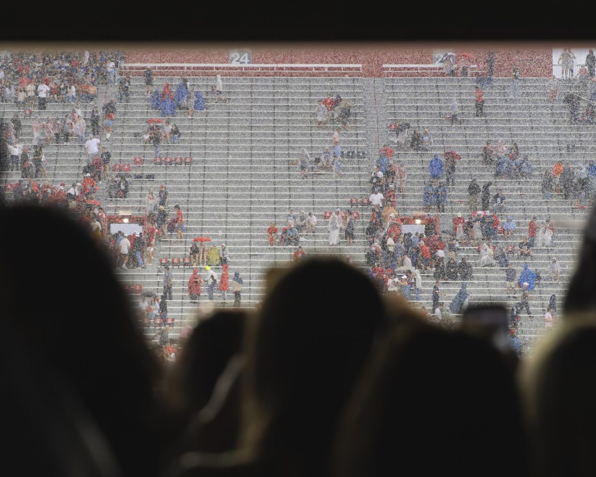 Fans wait out the rain showers at Arizona Stadium on Oct. 11 on Family Weekend vs BYU.