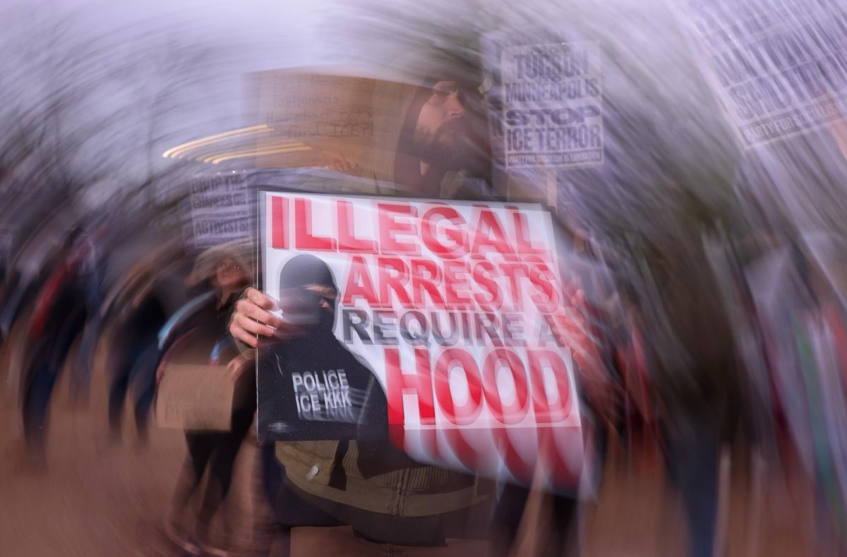 A protestor holds a sign at Freedom Park on Jan. 24.