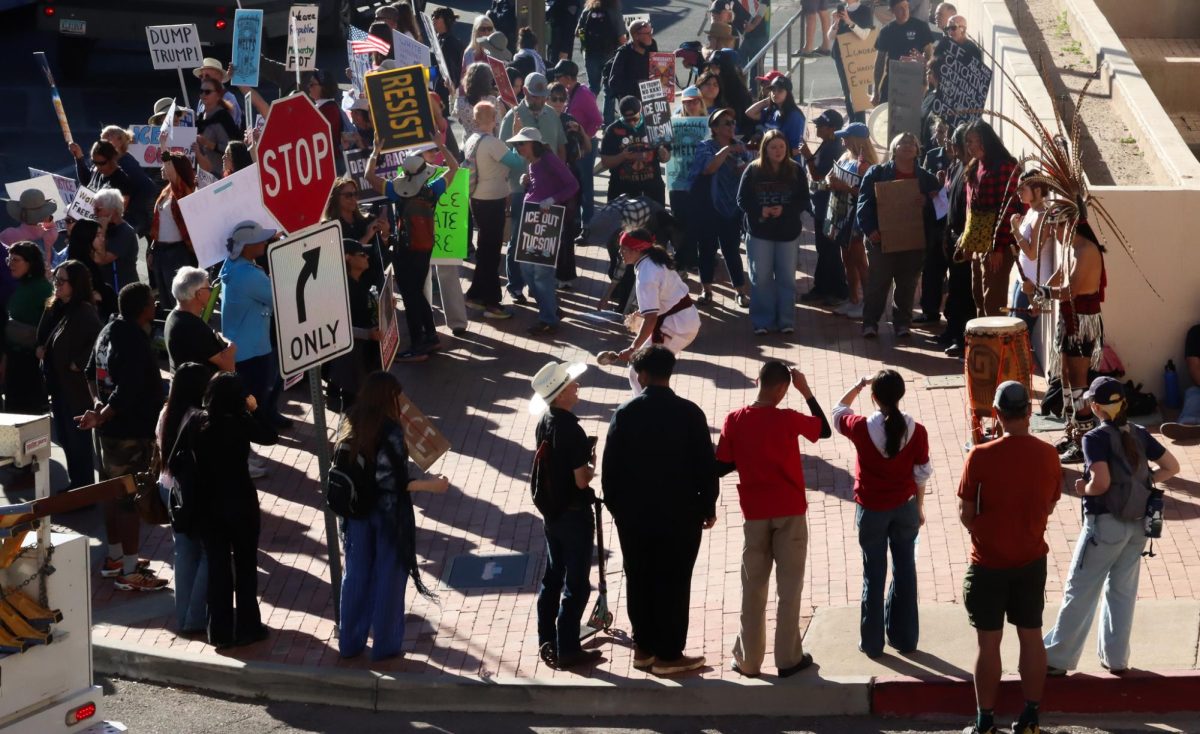 Protestors gather around a man doing a Native American dance on Congress Street on Jan. 20.