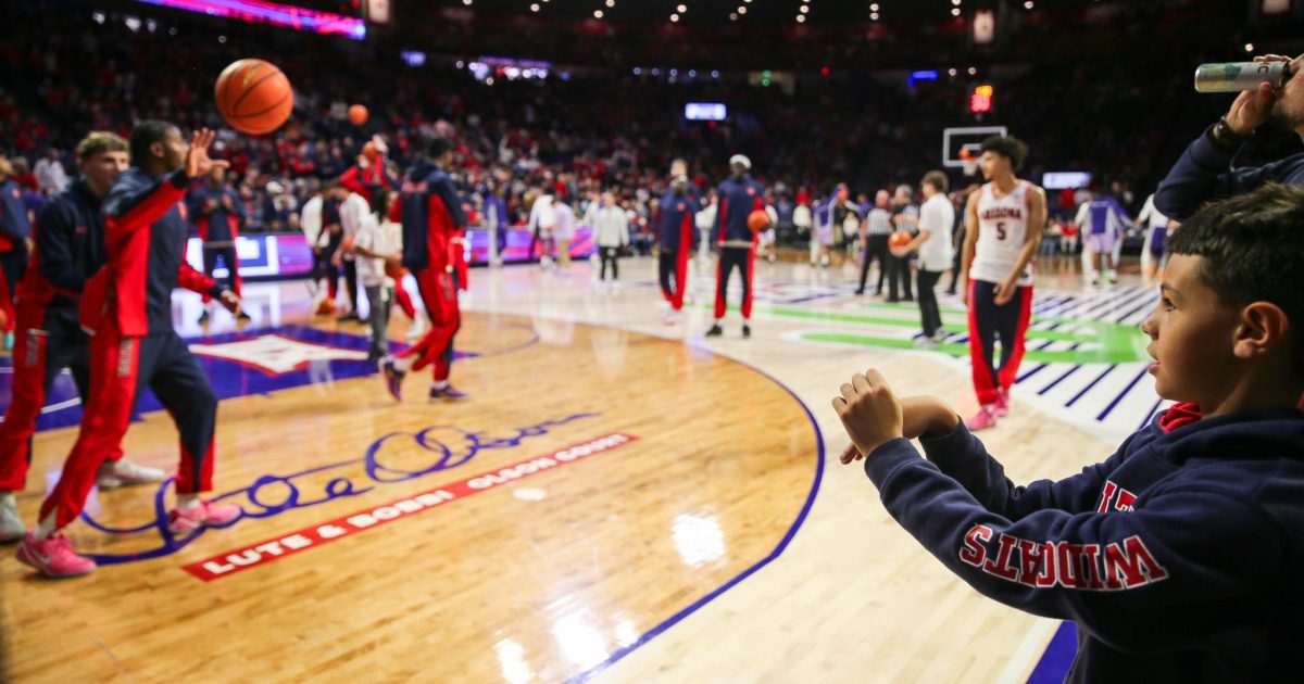 Jaden Bradley catches an inbound pass from a young fan before Arizona's home conference opener against Kansas State in McKale Center on Jan. 7.