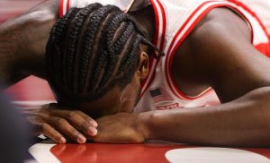 Jaden Bradley takes a moment on the floor after taking a hard foul against Kansas State in McKale Center on Jan. 7.