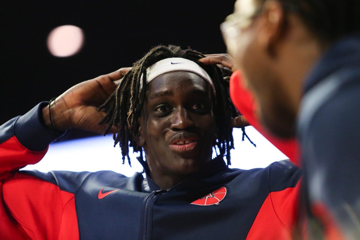 Sidi Gueye looks at Bryce James after Jaden Bradley sinks a three pointer against Kansas State in McKale Center on Jan. 7.