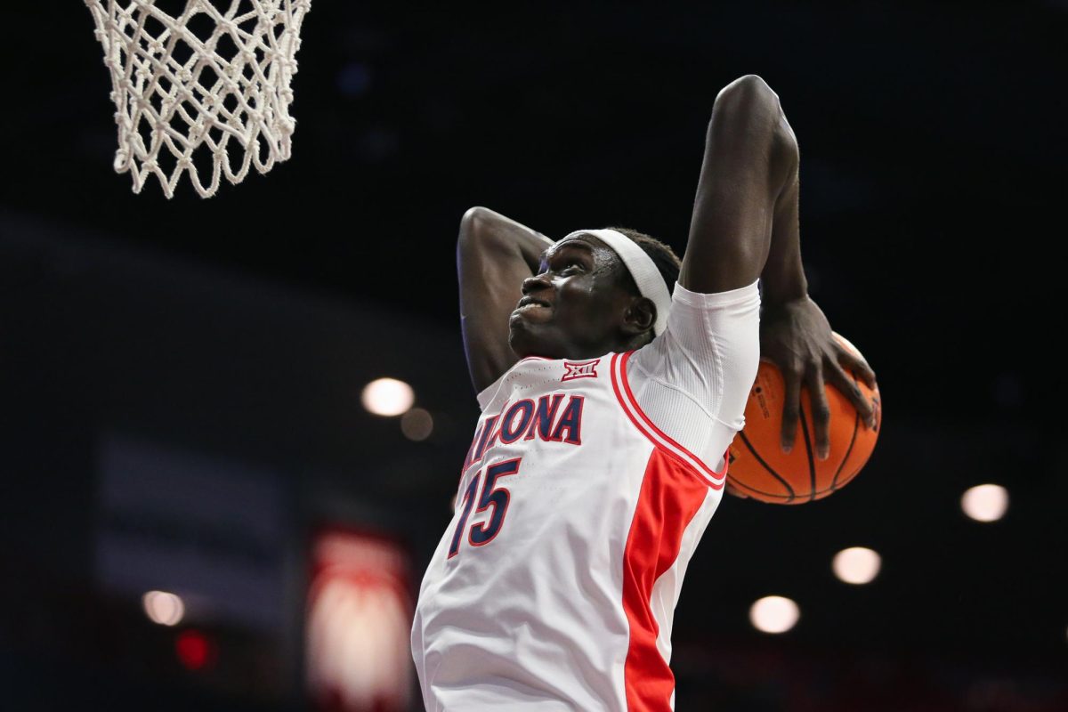 Sidi Gueye tomahawk dunks late in the game against Kansas State in McKale Center on Jan. 7.