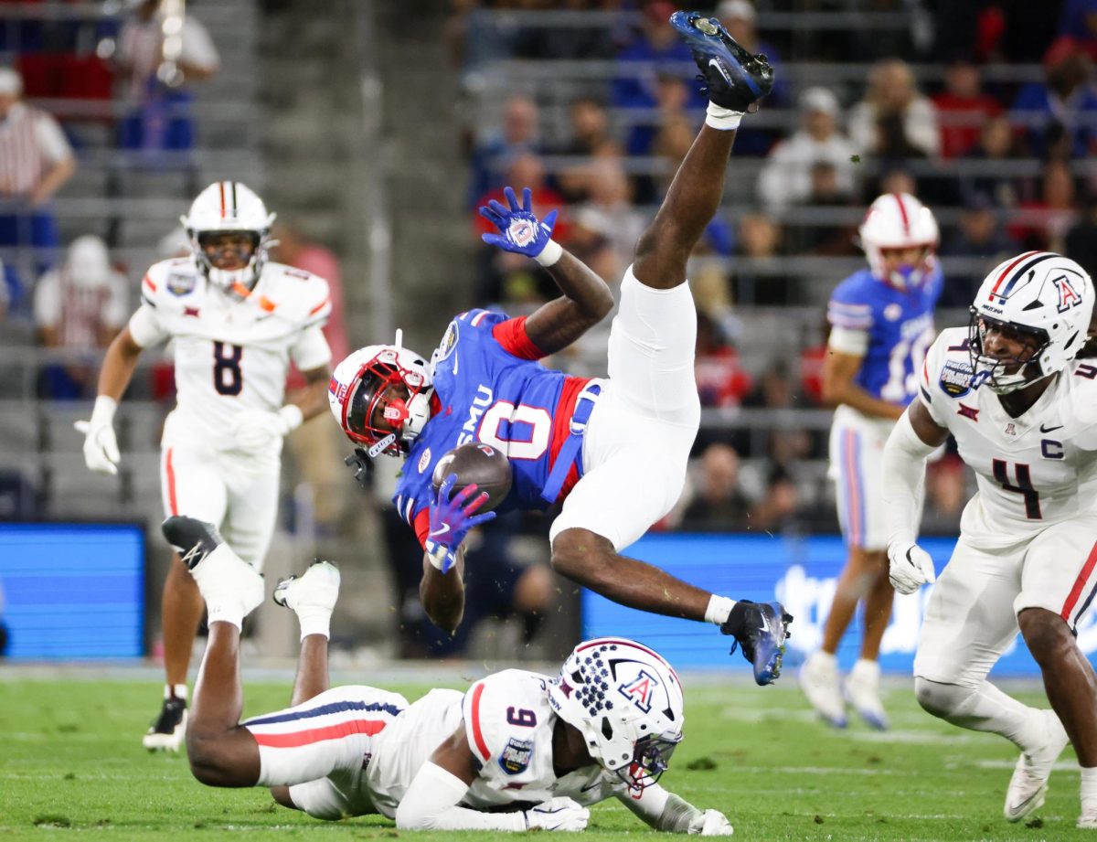 Ayden Garnes sends an SMU player airborne  in the Holiday Bowl at Snapdragon Stadium in San Diego on Jan. 2.